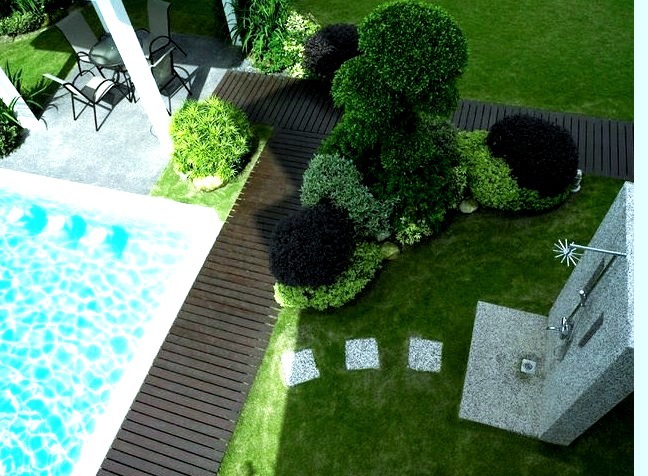 Large minimalist backyard rectangular natural pool house photo with decking